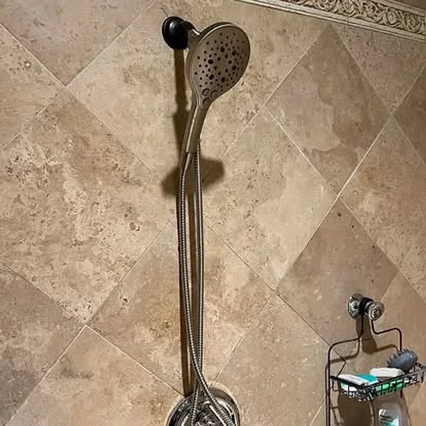 Tiled shower with a single handheld showerhead before the upgrade